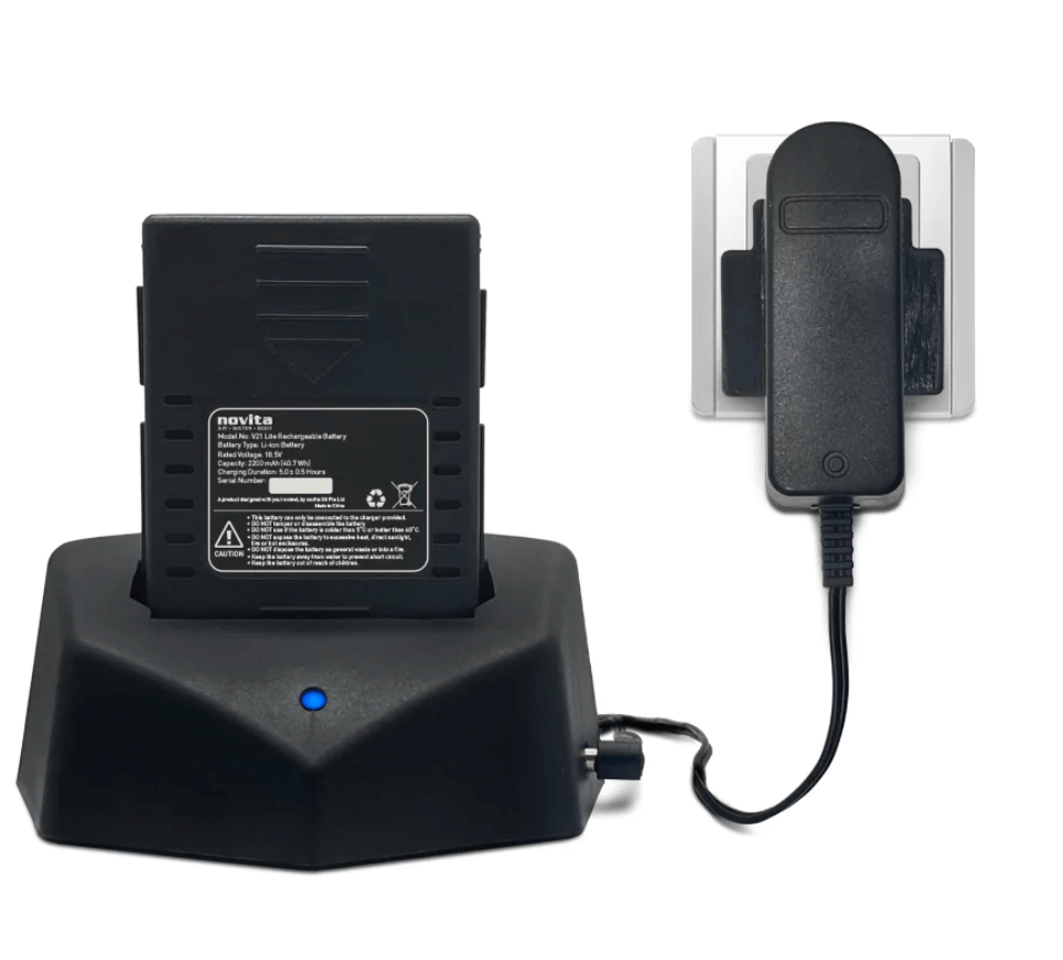 A battery charger with a phone attached to it.