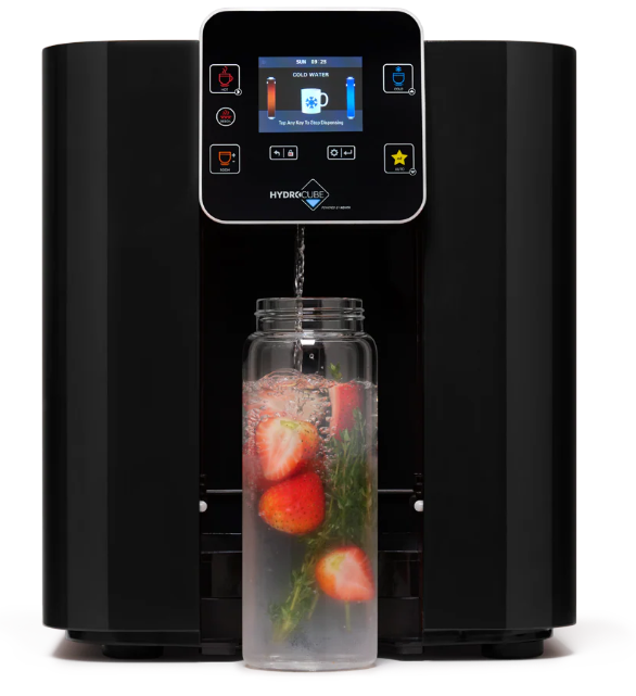 A compact water dispenser fills a clear bottle containing ice, strawberries, and green herbs in a modern kitchen. The dispenser’s display shows options for water types and settings, making it a stylish and functional addition to any Singapore home.