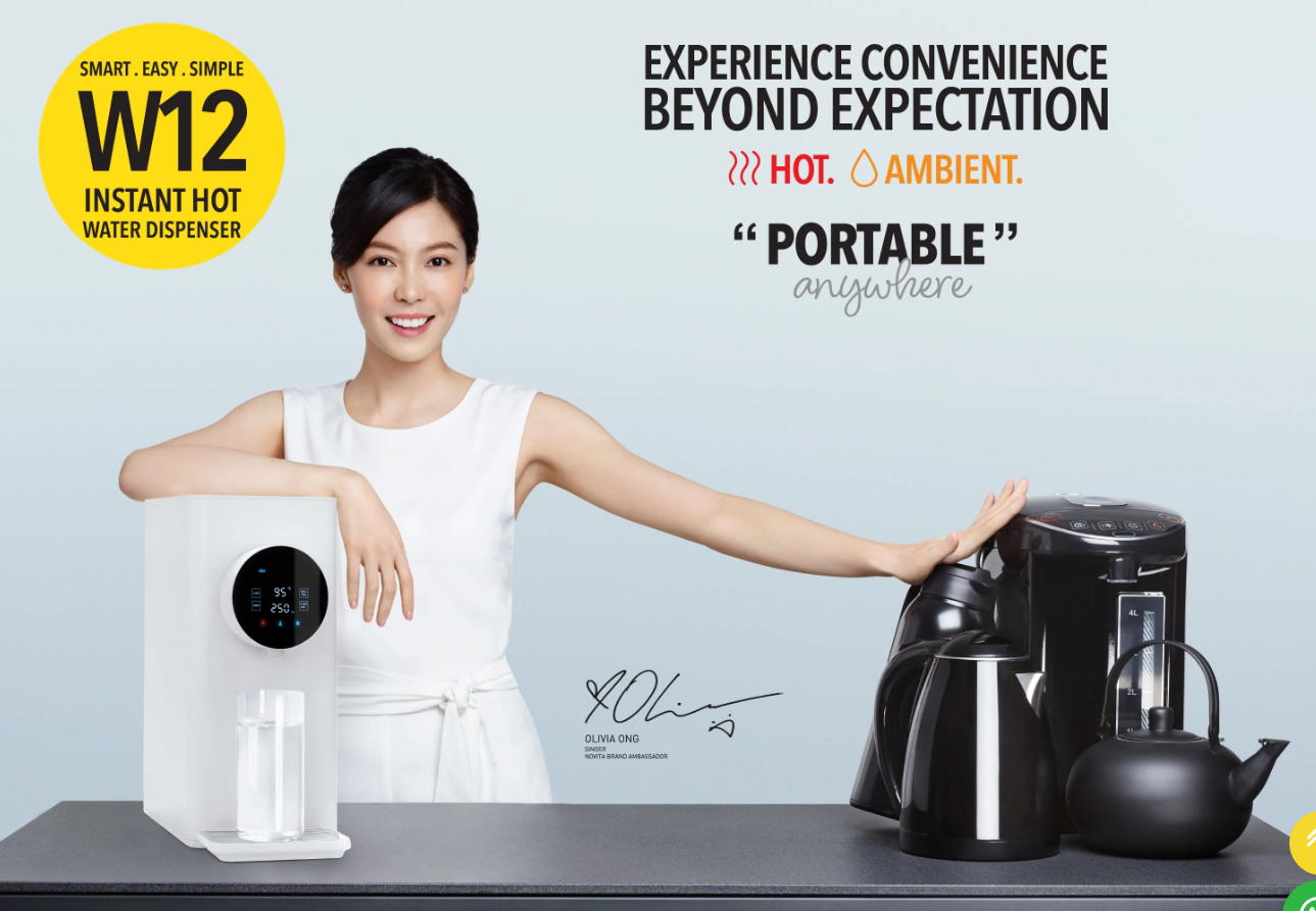 A woman stands beside a white Model W12 compact water dispenser and black appliances on a worktop in one of the modern kitchens in Singapore, smiling, with promotional text in the background.