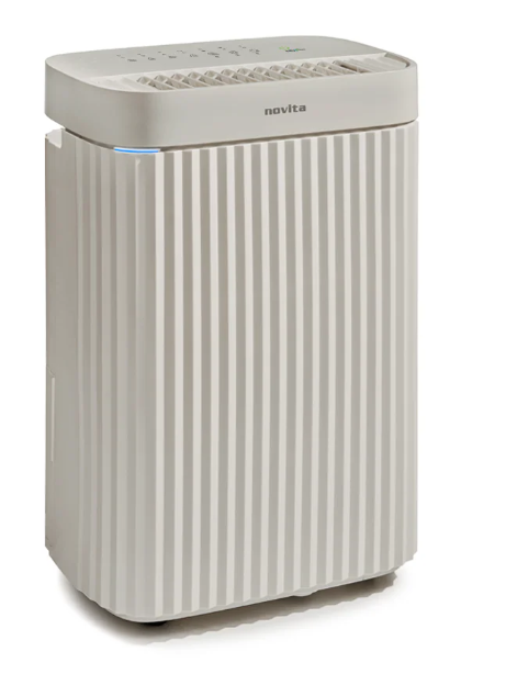 A beige Novita air purifier with vertical ridges, control buttons on top, and a small indicator light stands on a white background—an ideal complement to energy-saving dehumidifiers for those who understand the importance of dehumidifiers in maintaining optimal indoor air quality.